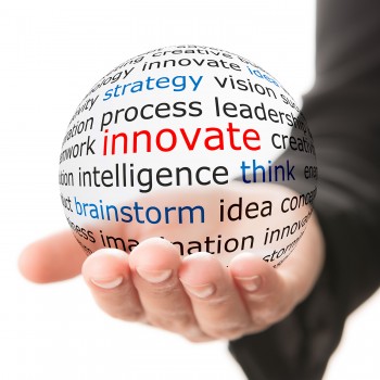 Hand holding a sphere with innovation words. Hand holding a sphere with innovation words.