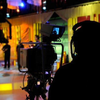 Camera operator silhouetted in a studio. Camera operator silhouetted in a studio.